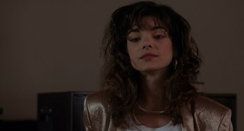 Movie still from “Sex, Lies, and Videotape” (1989), directed by Steven Soderbergh – A woman with long brown hair wearing a white shirt; Close Up shot, Over the shoulder angle