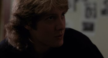 Movie still from “Sex, Lies, and Videotape” (1989), directed by Steven Soderbergh – A young man with blonde hair and blue eyes stares ahead; Close Up shot, Over the shoulder angle