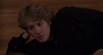Movie still from “Sex, Lies, and Videotape” (1989), directed by Steven Soderbergh – A young man laying on the ground with his head resting on his arm; Close Up shot, High angle