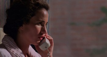 Movie still from “Sex, Lies, and Videotape” (1989), directed by Steven Soderbergh – A person talking on a cell phone; Close Up shot, Low angle