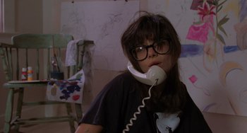 Movie still from “Sex, Lies, and Videotape” (1989), directed by Steven Soderbergh – A woman with glasses is talking on a phone; Close Up shot, High angle