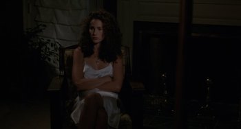 Movie still from “Sex, Lies, and Videotape” (1989), directed by Steven Soderbergh – A woman sitting in a chair in front of a fire place; Medium shot, Over the shoulder angle