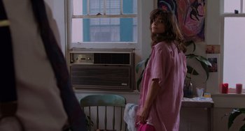 Movie still from “Sex, Lies, and Videotape” (1989), directed by Steven Soderbergh – A woman standing in front of an air conditioning unit; Medium shot, Over the shoulder angle