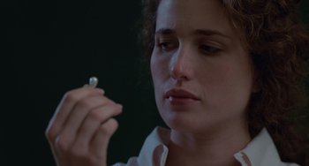 Movie still from “Sex, Lies, and Videotape” (1989), directed by Steven Soderbergh – A person holding a diamond in her hand; Close Up shot, Over the shoulder angle