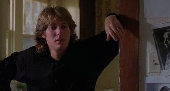 Movie still from “Sex, Lies, and Videotape” (1989), directed by Steven Soderbergh – A man leaning against a wall in a living room; Close Up shot, Low angle