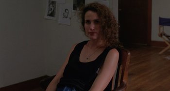 Movie still from “Sex, Lies, and Videotape” (1989), directed by Steven Soderbergh – A woman sitting in a wooden chair in front of a wall; Close Up shot, High angle