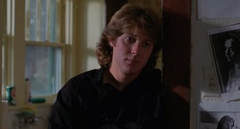 Movie still from “Sex, Lies, and Videotape” (1989), directed by Steven Soderbergh – A young man with long hair and a black shirt; Close Up shot, Low angle