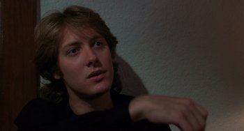 Movie still from “Sex, Lies, and Videotape” (1989), directed by Steven Soderbergh – A man in a black t - shirt is looking into the distance; Close Up shot, Low angle