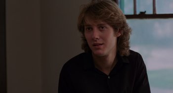 Movie still from “Sex, Lies, and Videotape” (1989), directed by Steven Soderbergh – A man with long hair and a black shirt; Close Up shot, Over the shoulder angle