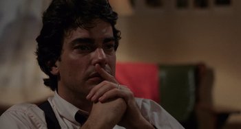 Movie still from “Sex, Lies, and Videotape” (1989), directed by Steven Soderbergh – A person sitting with his hand on his chin; Close Up shot, High angle