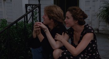 Movie still from “Sex, Lies, and Videotape” (1989), directed by Steven Soderbergh – A man and a woman sitting next to each other on a porch; Medium shot, Over the shoulder angle