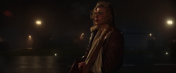 Movie still from “Shadow in the Cloud” (2020), directed by Roseanne Liang – A woman in a brown jacket and a white scarf; Medium shot, Over the shoulder angle