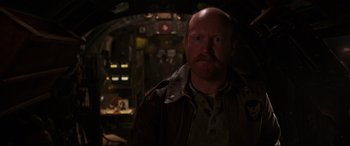 Movie still from “Shadow in the Cloud” (2020), directed by Roseanne Liang – A man with a beard wearing a leather jacket; Close Up shot, Low angle