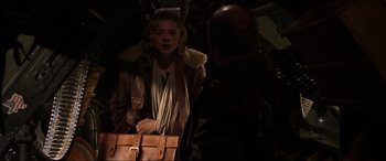 Movie still from “Shadow in the Cloud” (2020), directed by Roseanne Liang – A woman in a brown jacket holding a brown briefcase; Medium shot, Over the shoulder angle