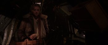 Movie still from “Shadow in the Cloud” (2020), directed by Roseanne Liang – A young woman standing in front of an organ; Medium shot, Low angle