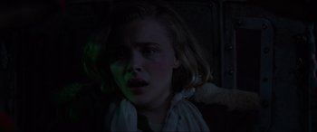 Movie still from “Shadow in the Cloud” (2020), directed by Roseanne Liang – A woman with a teddy bear in a dark room; Close Up shot, High angle