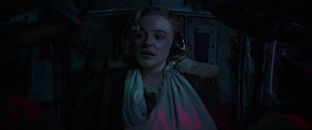 Movie still from “Shadow in the Cloud” (2020), directed by Roseanne Liang – A woman with headphones and a blanket around her neck; Medium shot, High angle