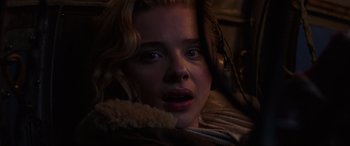 Movie still from “Shadow in the Cloud” (2020), directed by Roseanne Liang – A person wearing headphones; Close Up shot, High angle