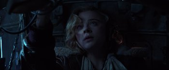 Movie still from “Shadow in the Cloud” (2020), directed by Roseanne Liang – A woman looking up at the ceiling in a dark room; Close Up shot, Low angle