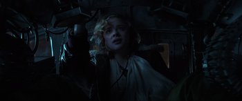 Movie still from “Shadow in the Cloud” (2020), directed by Roseanne Liang – A woman with blonde curly hair is looking at the camera; Close Up shot, Low angle