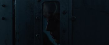 Movie still from “Shadow in the Cloud” (2020), directed by Roseanne Liang – A woman looking through a window at night; Close Up shot, Over the shoulder angle