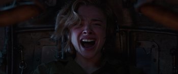 Movie still from “Shadow in the Cloud” (2020), directed by Roseanne Liang – A young woman with blonde ringlet hair is screaming; Close Up shot, Overhead angle