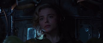 Movie still from “Shadow in the Cloud” (2020), directed by Roseanne Liang – A woman with headphones is looking at the camera; Close Up shot, Low angle