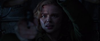 Movie still from “Shadow in the Cloud” (2020), directed by Roseanne Liang – A person with blood on their face; Close Up shot, Over the shoulder angle