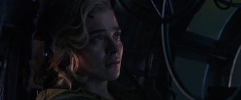 Movie still from “Shadow in the Cloud” (2020), directed by Roseanne Liang – A person wearing a green shirt; Close Up shot, High angle