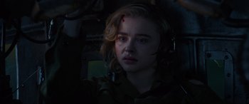 Movie still from “Shadow in the Cloud” (2020), directed by Roseanne Liang – A woman with a bandage on her face; Close Up shot, High angle