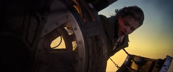 Movie still from “Shadow in the Cloud” (2020), directed by Roseanne Liang – A man is looking into a propeller of an airplane; Medium shot, Low angle