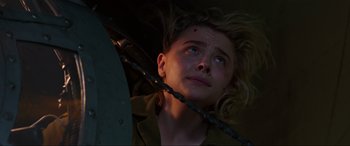 Movie still from “Shadow in the Cloud” (2020), directed by Roseanne Liang – A young man with a knife in his mouth looking up; Close Up shot, Low angle