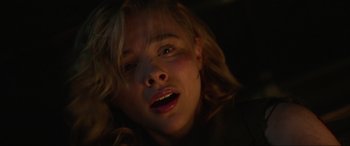 Movie still from “Shadow in the Cloud” (2020), directed by Roseanne Liang – A young woman with blonde hair and a red lipstick; Close Up shot, Low angle