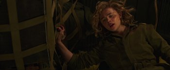 Movie still from “Shadow in the Cloud” (2020), directed by Roseanne Liang – A young woman is laying in the dark; Close Up shot, Low angle