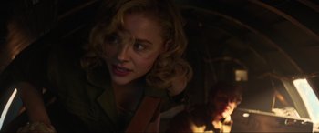 Movie still from “Shadow in the Cloud” (2020), directed by Roseanne Liang – A person with a gun in a dark room; Close Up shot, Over the shoulder angle