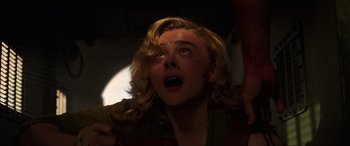 Movie still from “Shadow in the Cloud” (2020), directed by Roseanne Liang – A woman with blonde hair looking up at the sky; Close Up shot, Low angle