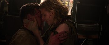 Movie still from “Shadow in the Cloud” (2020), directed by Roseanne Liang – Two people are hugging in a dark room; Close Up shot, Over the shoulder angle