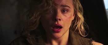 Movie still from “Shadow in the Cloud” (2020), directed by Roseanne Liang – A woman's face as she stares into the camera; Close Up shot, High angle