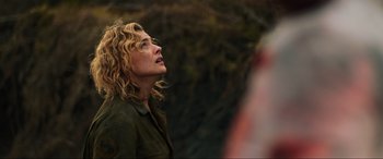 Movie still from “Shadow in the Cloud” (2020), directed by Roseanne Liang – A woman with blonde curly hair looking up; Close Up shot, Over the shoulder angle