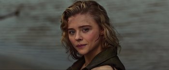 Movie still from “Shadow in the Cloud” (2020), directed by Roseanne Liang – A person with a scar on their face; Close Up shot, High angle