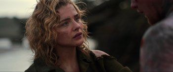 Movie still from “Shadow in the Cloud” (2020), directed by Roseanne Liang – A person with blonde curly hair; Close Up shot, Low angle