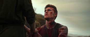 Movie still from “Shadow in the Cloud” (2020), directed by Roseanne Liang – A young man with blood on his face holding a baseball bat; Close Up shot, Over the shoulder angle