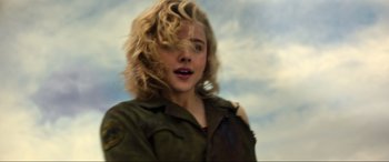Movie still from “Shadow in the Cloud” (2020), directed by Roseanne Liang – A woman with blonde hair is standing in the wind; Close Up shot, Low angle