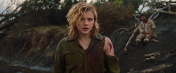 Movie still from “Shadow in the Cloud” (2020), directed by Roseanne Liang – A young woman with blonde hair and a scar on her arm; Close Up shot, Over the shoulder angle