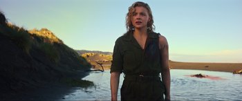 Movie still from “Shadow in the Cloud” (2020), directed by Roseanne Liang – A woman standing in front of a body of water; Medium shot, Low angle