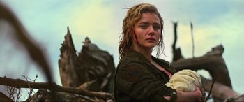 Movie still from “Shadow in the Cloud” (2020), directed by Roseanne Liang – A young woman with long blonde hair standing in the woods; Close Up shot, Over the shoulder angle