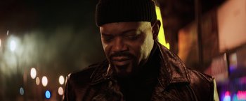 Movie still from “Shaft” (2019), directed by Tim Story – A person wearing a jacket and a hat; Close Up shot, Low angle