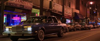 Movie still from “Shaft” (2019), directed by Tim Story – A car parked on the side of the street at night; Wide shot, High angle