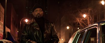 Movie still from “Shaft” (2019), directed by Tim Story – A man wearing a leather jacket and a hat; Medium shot, Low angle