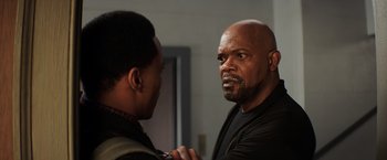Movie still from “Shaft” (2019), directed by Tim Story – A man standing next to another man in front of a mirror; Close Up shot, Over the shoulder angle